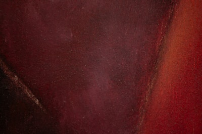 Abstract painting blending dark hues with refined burgundy and gold touches.