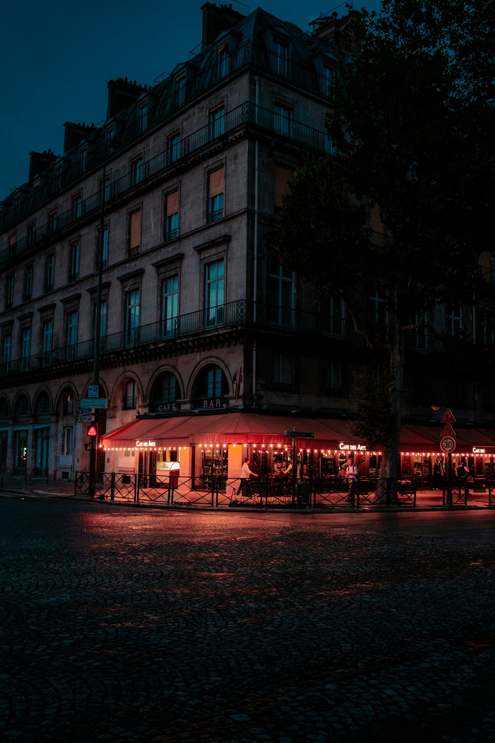 a building lit up at night with red lights