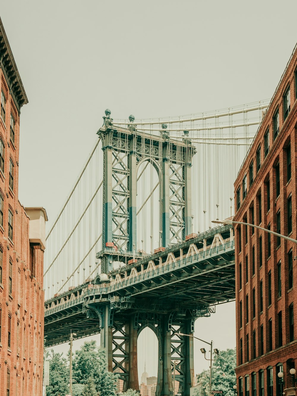 a large bridge spanning over a city with tall buildings