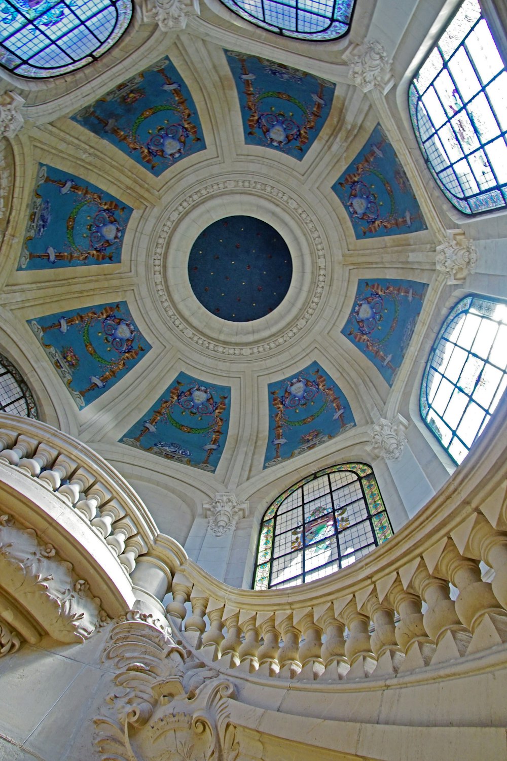 the ceiling of a large building with many windows