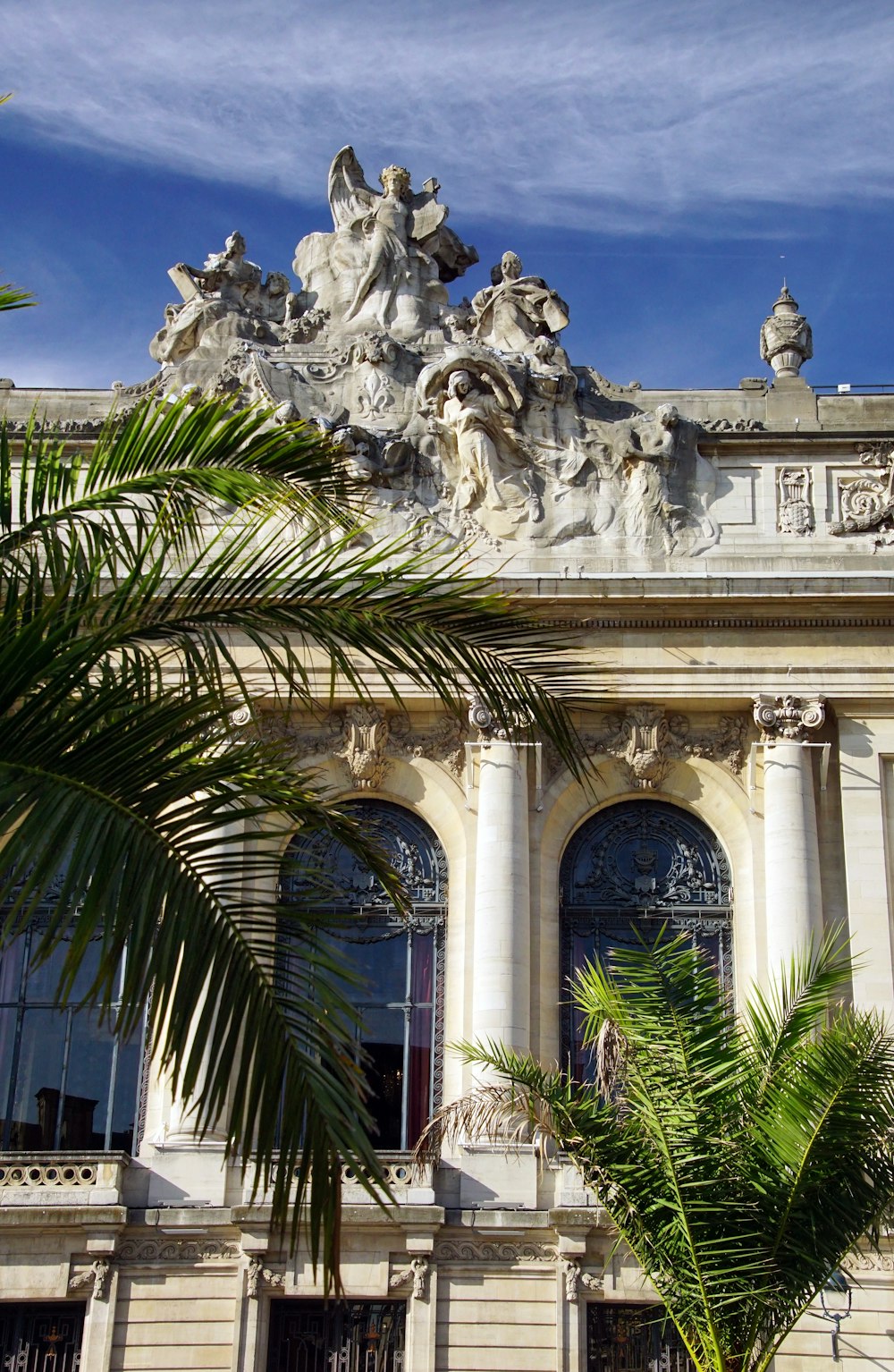 a large building with a palm tree in front of it