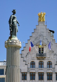 a tall building with a statue on top of it