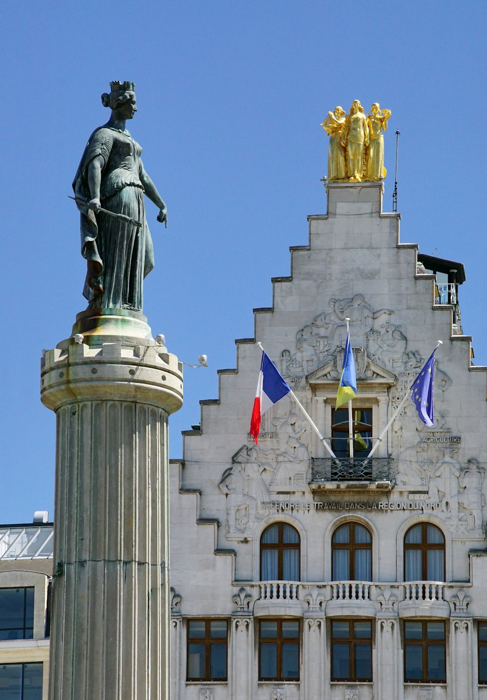 a tall building with a statue on top of it