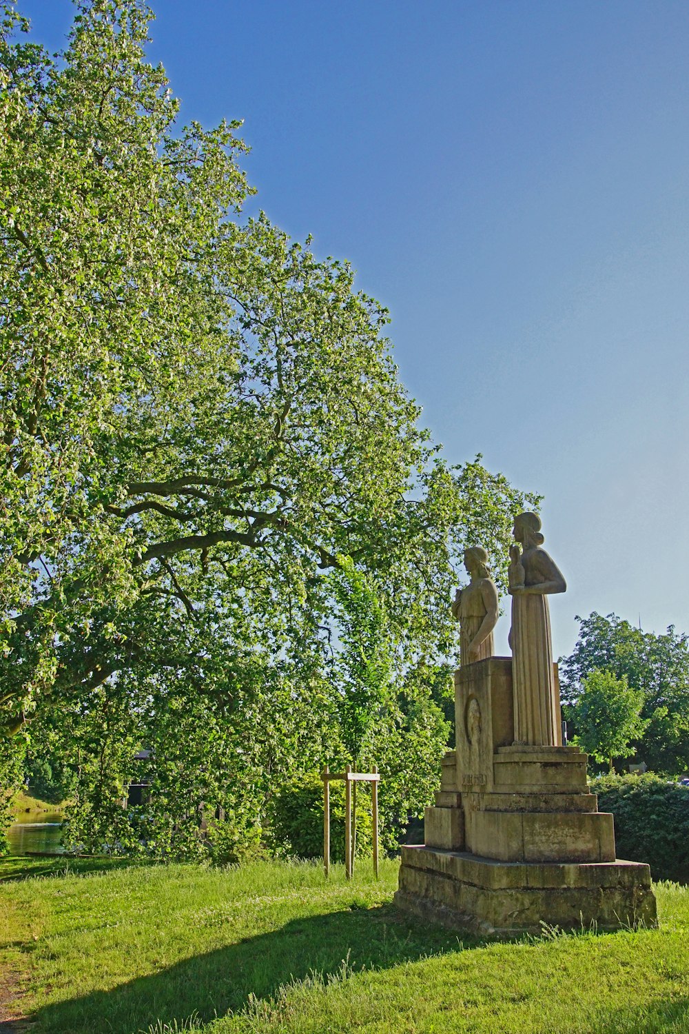 a statue in the middle of a grassy field