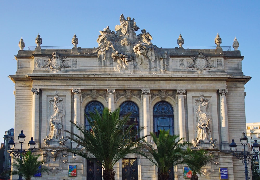 a large building with statues on top of it