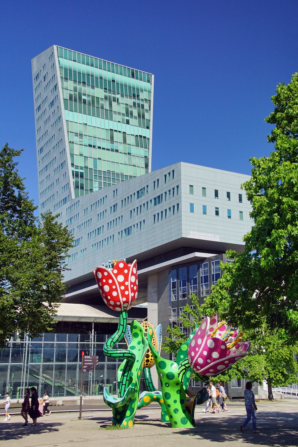 a sculpture of a dragon and a flower in front of a building