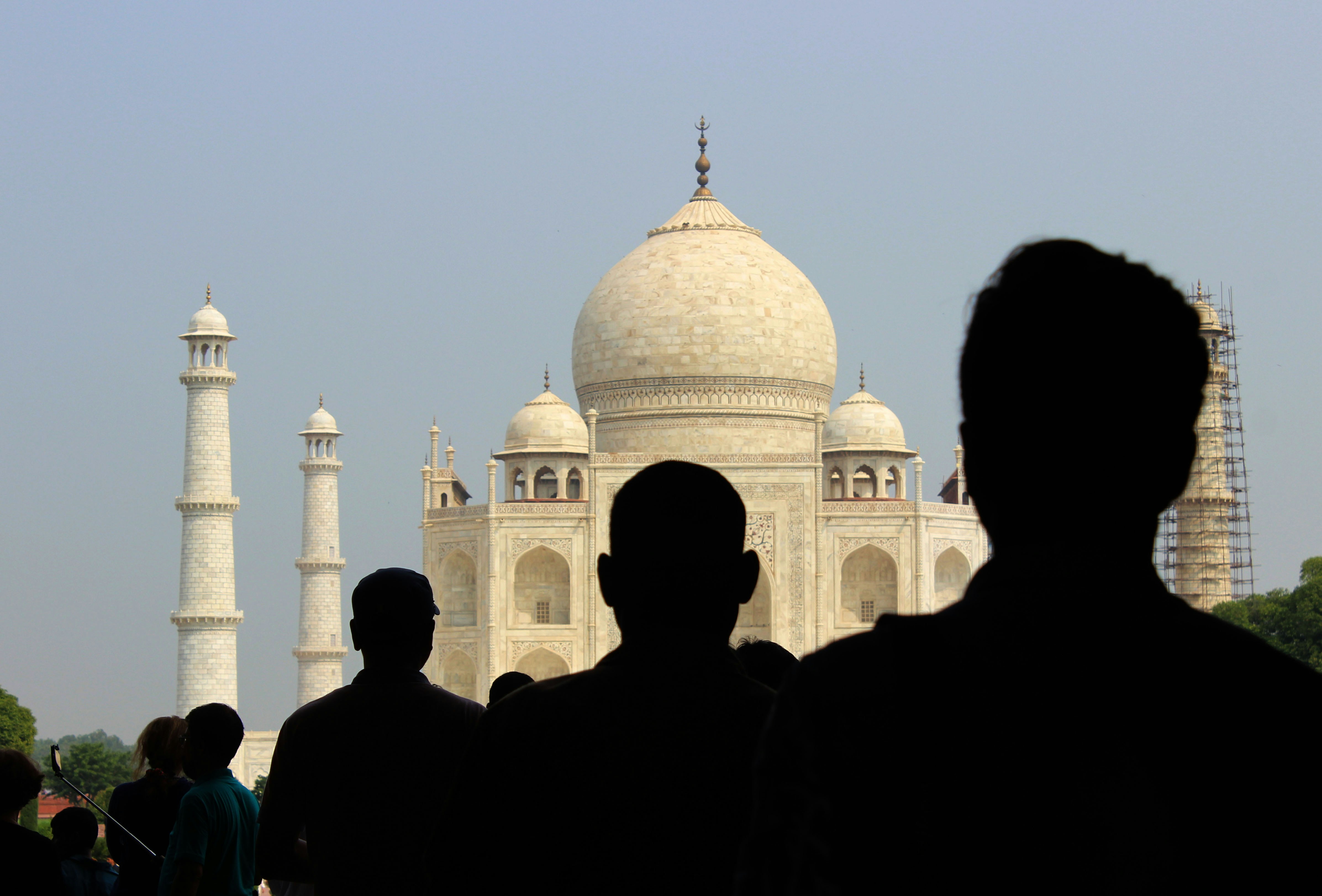 a group of people standing in front of a white building