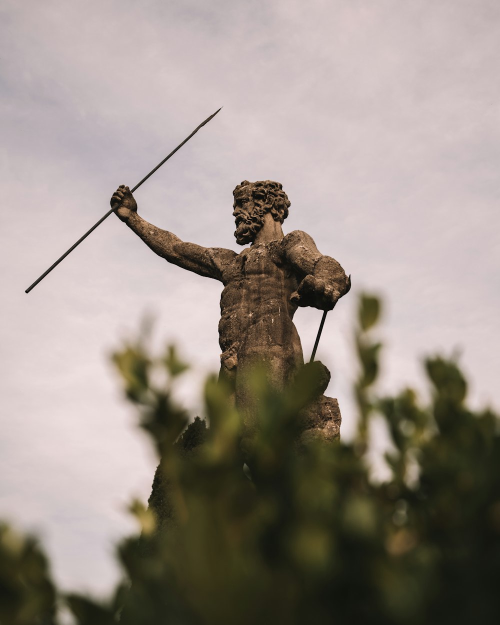 a statue of a man holding a spear