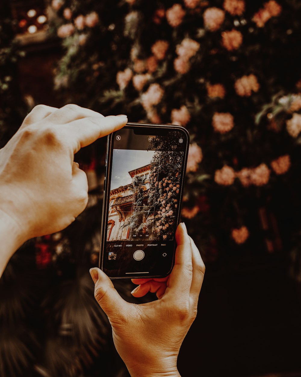 a person taking a picture with a cell phone