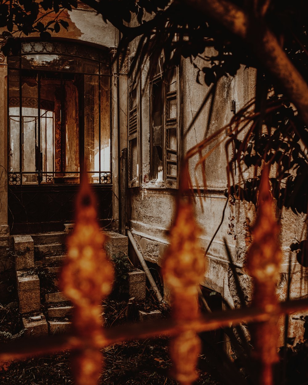 an old run down building with a fire hydrant in front of it