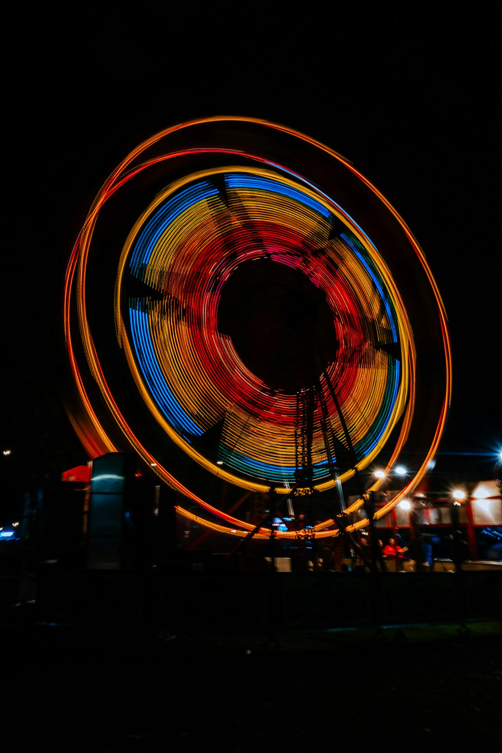 a ferris wheel spinning in the dark at night