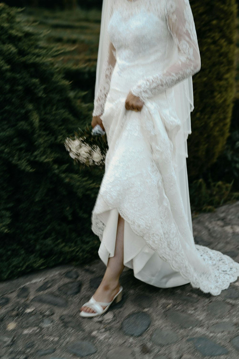 a woman in a white wedding dress and veil