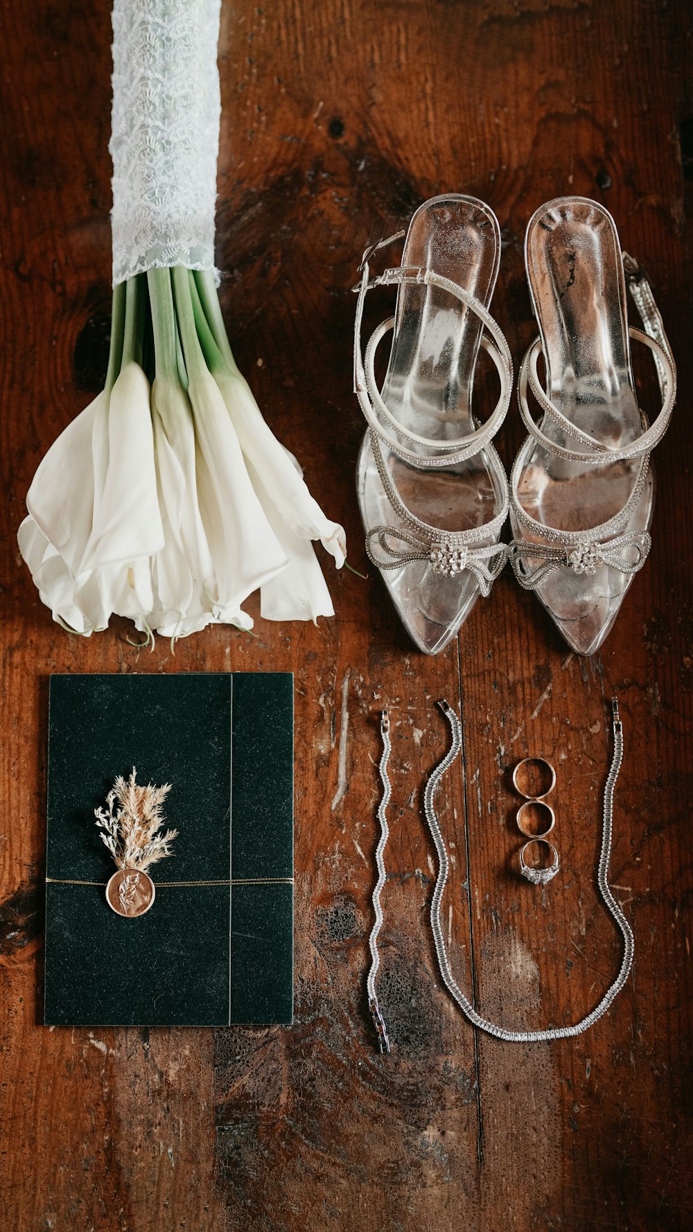 a pair of shoes and a bouquet of flowers on a table
