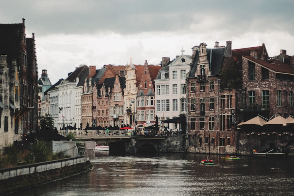 a river running through a city next to tall buildings