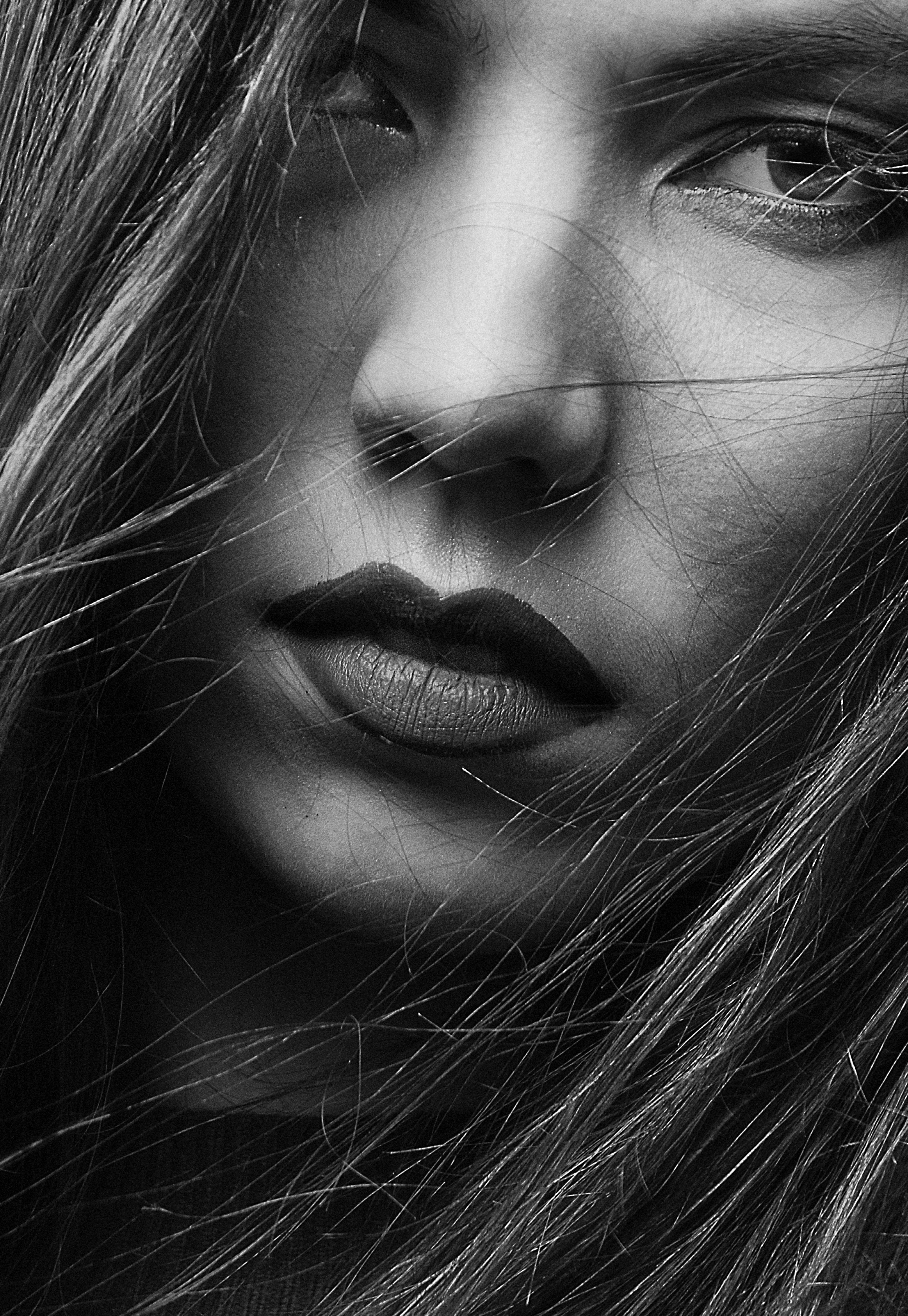 a black and white photo of a woman with long hair