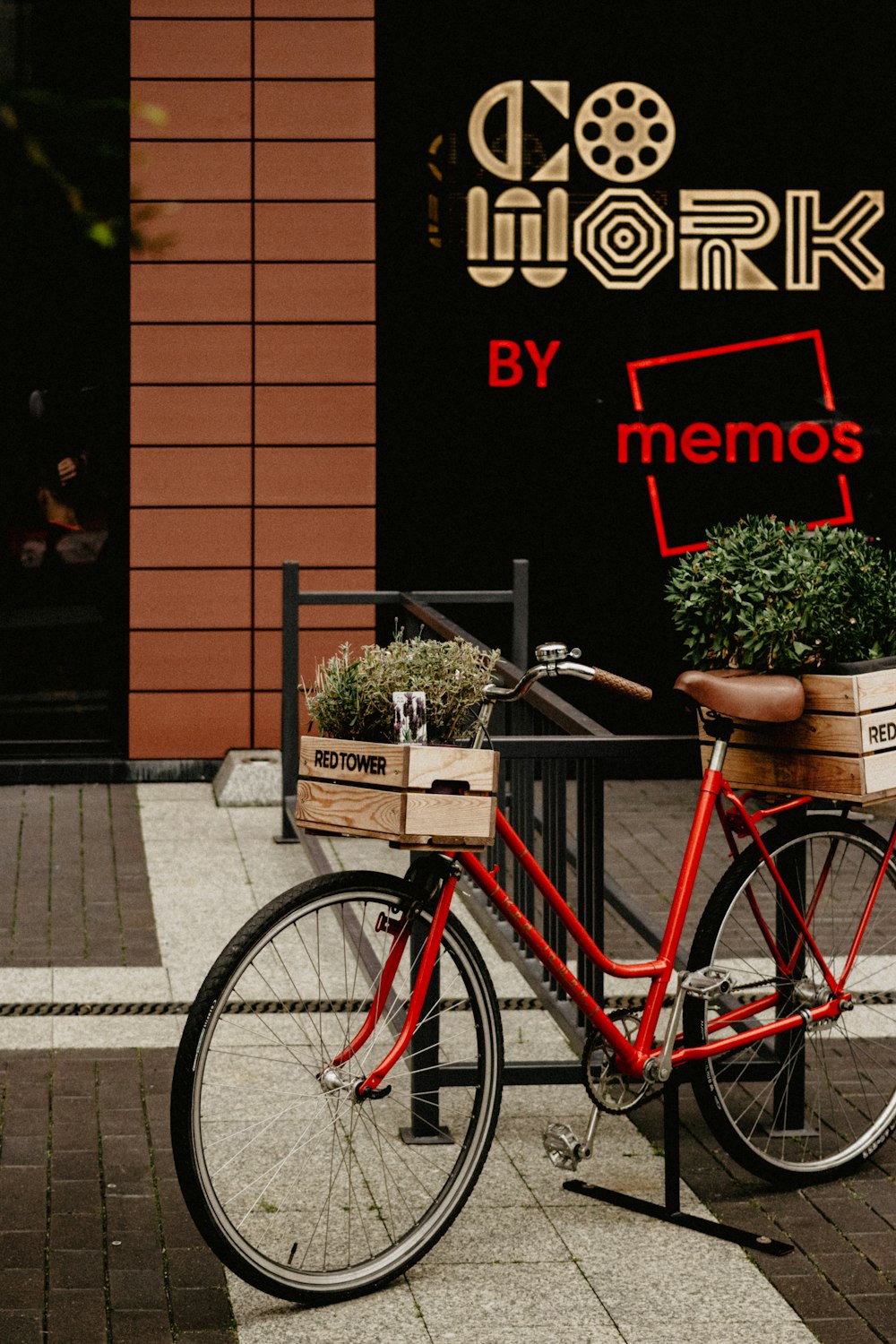 a red bike parked on the side of a street