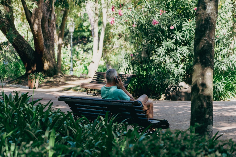 a woman sitting on a bench in a park