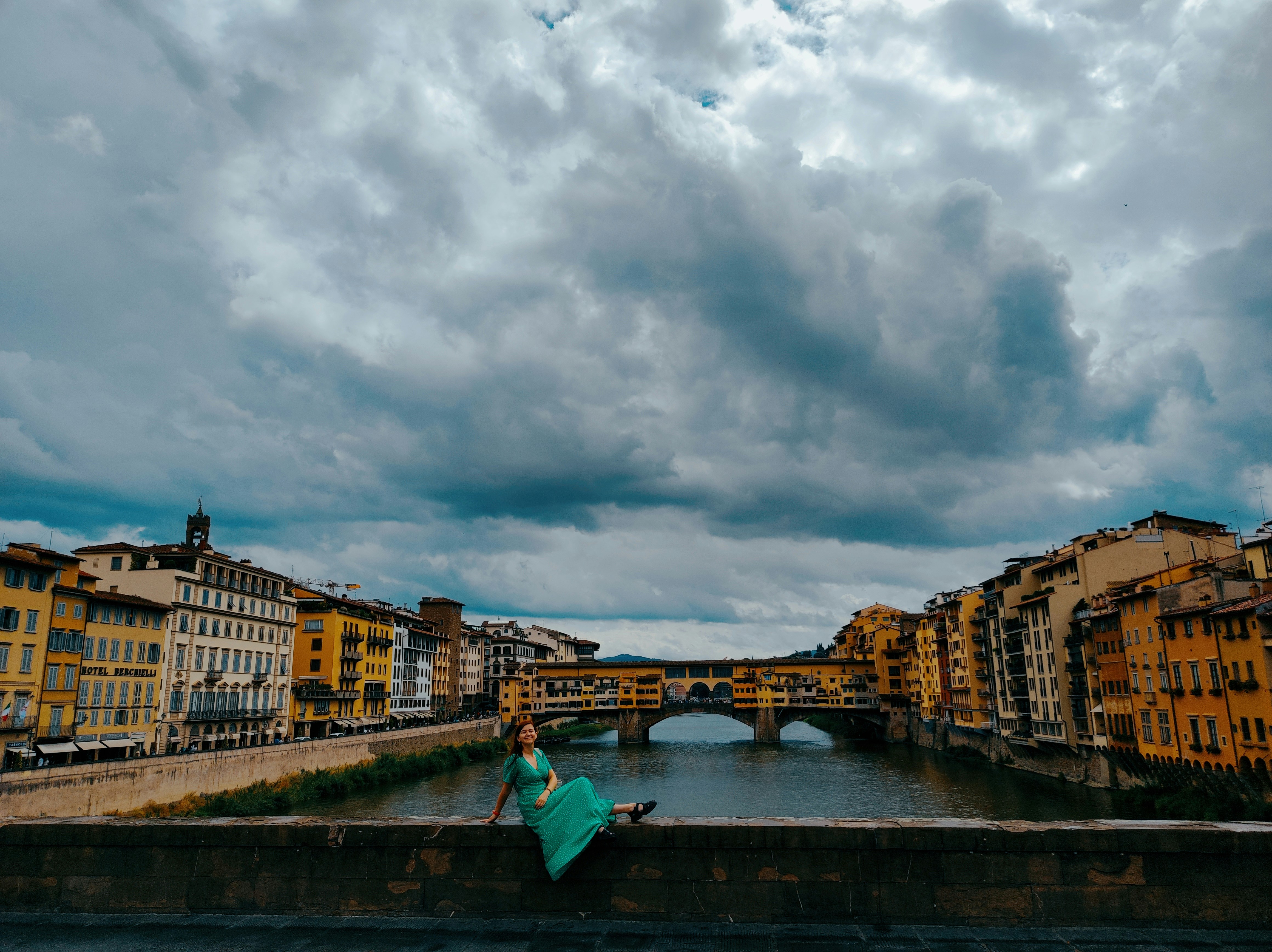 Chiara on a Florence bridge with the Arno river behind her