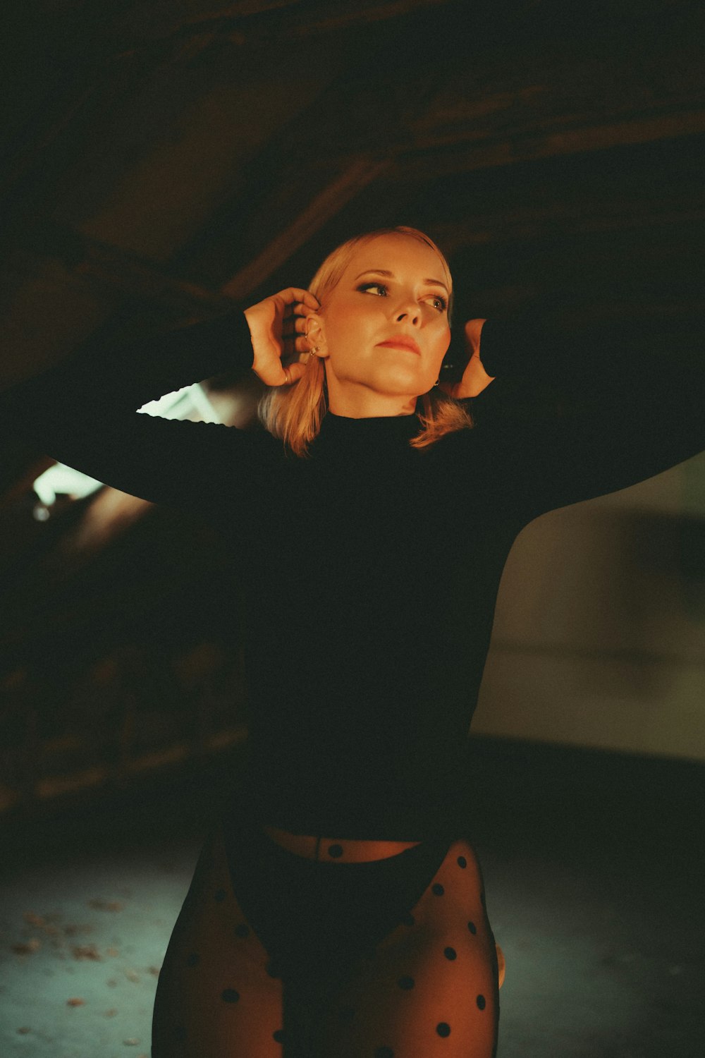 a woman in a black shirt and polka dot tights