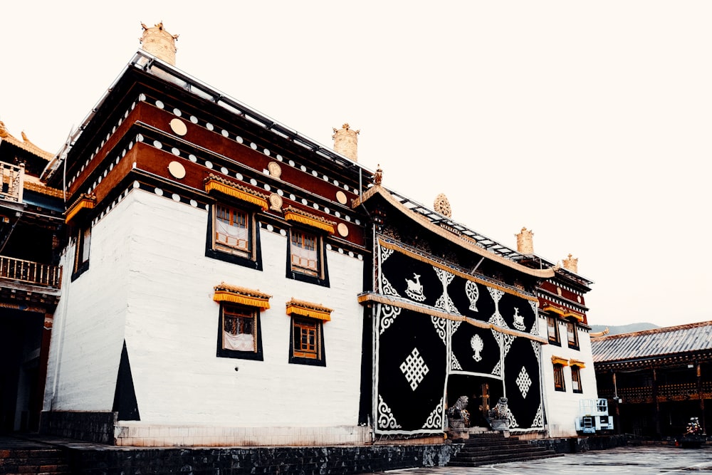 a white and black building with a clock on the top of it