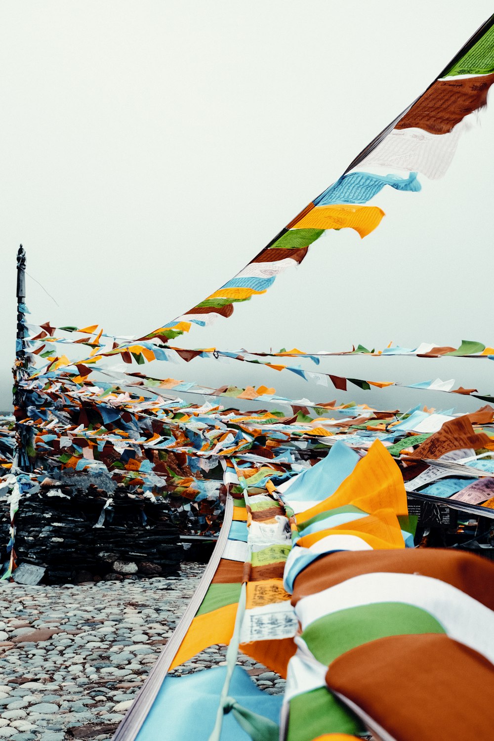 a bunch of colorful flags flying in the air