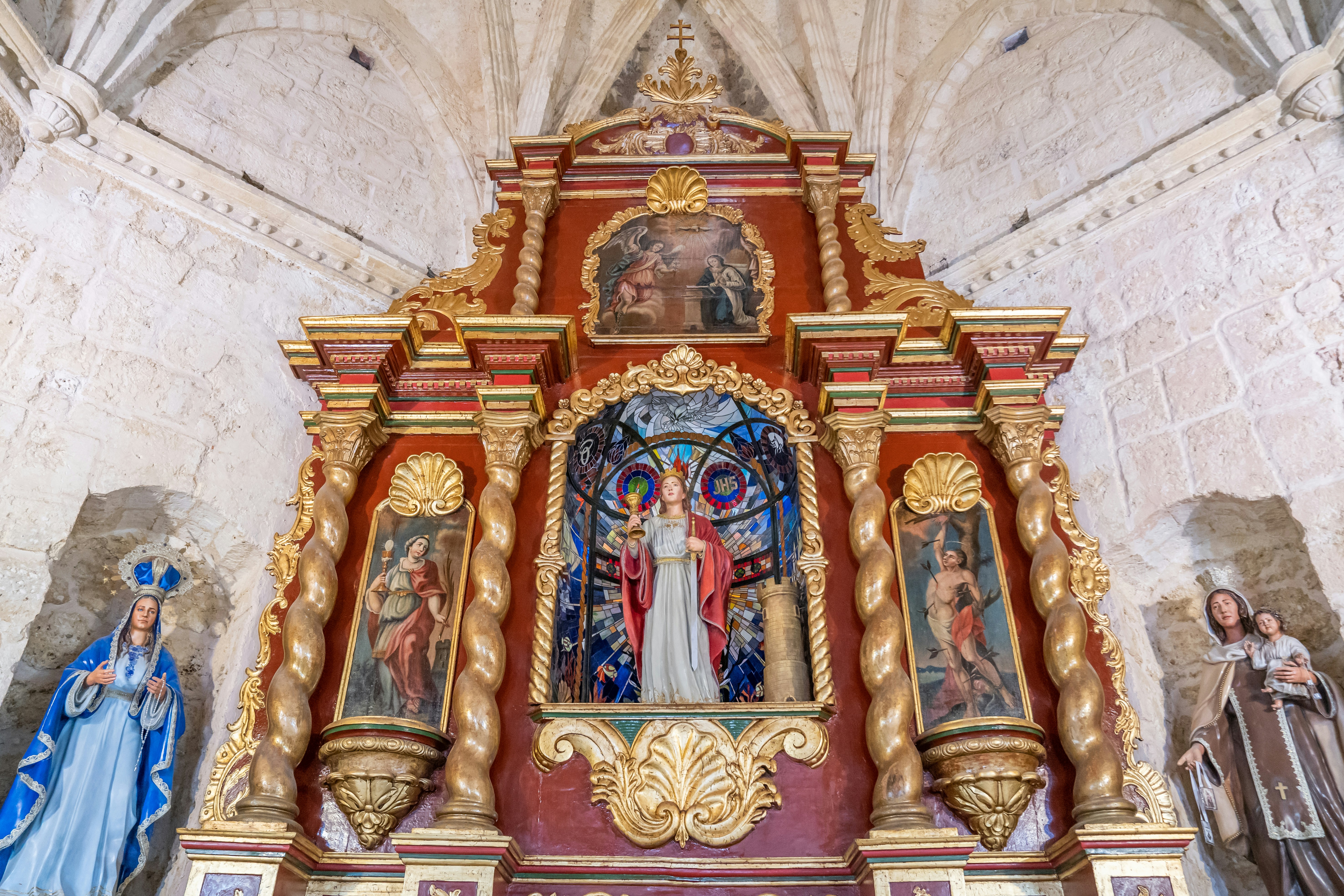 a church with a statue of the virgin mary and other religious figures