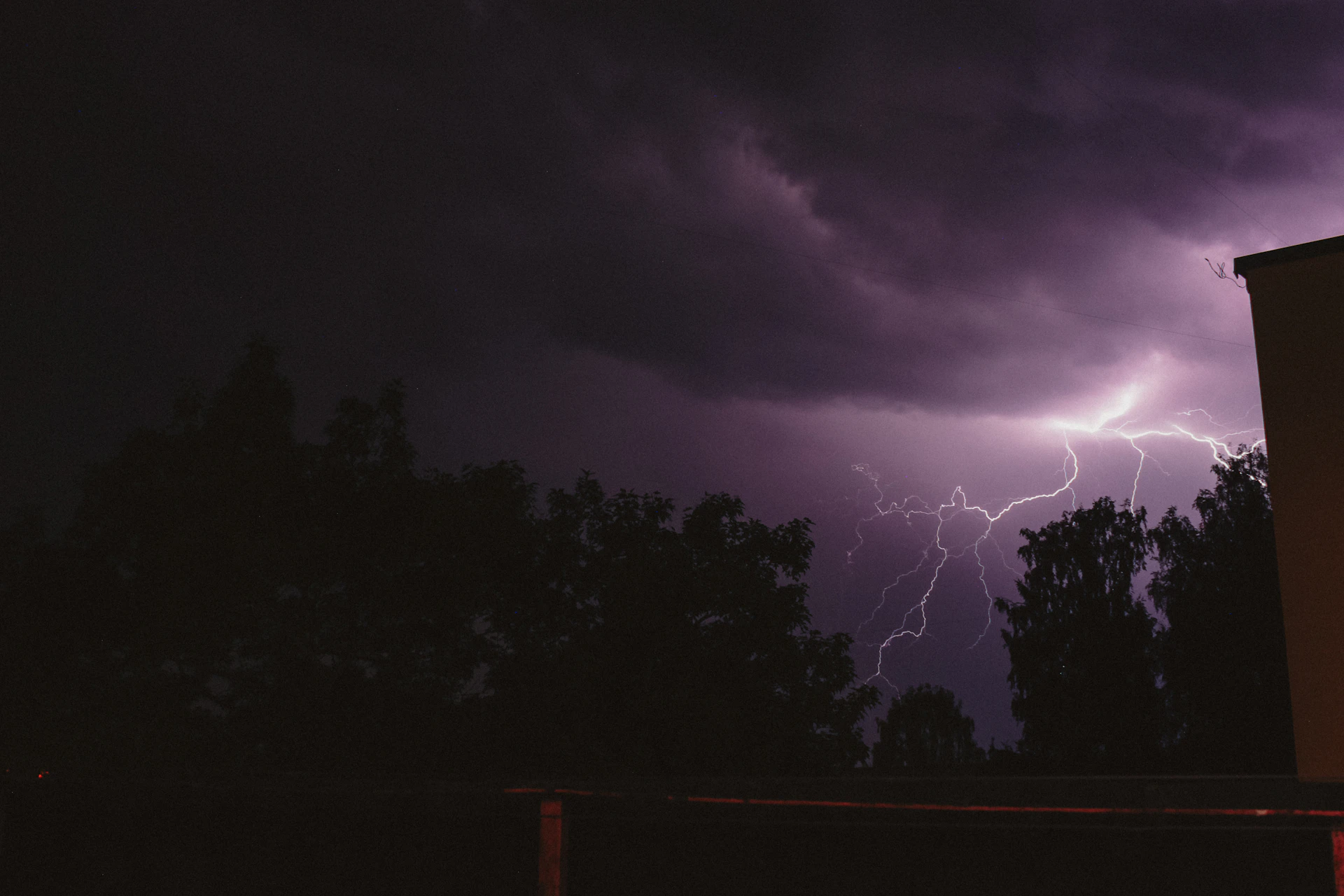 a lightning storm is seen over a building