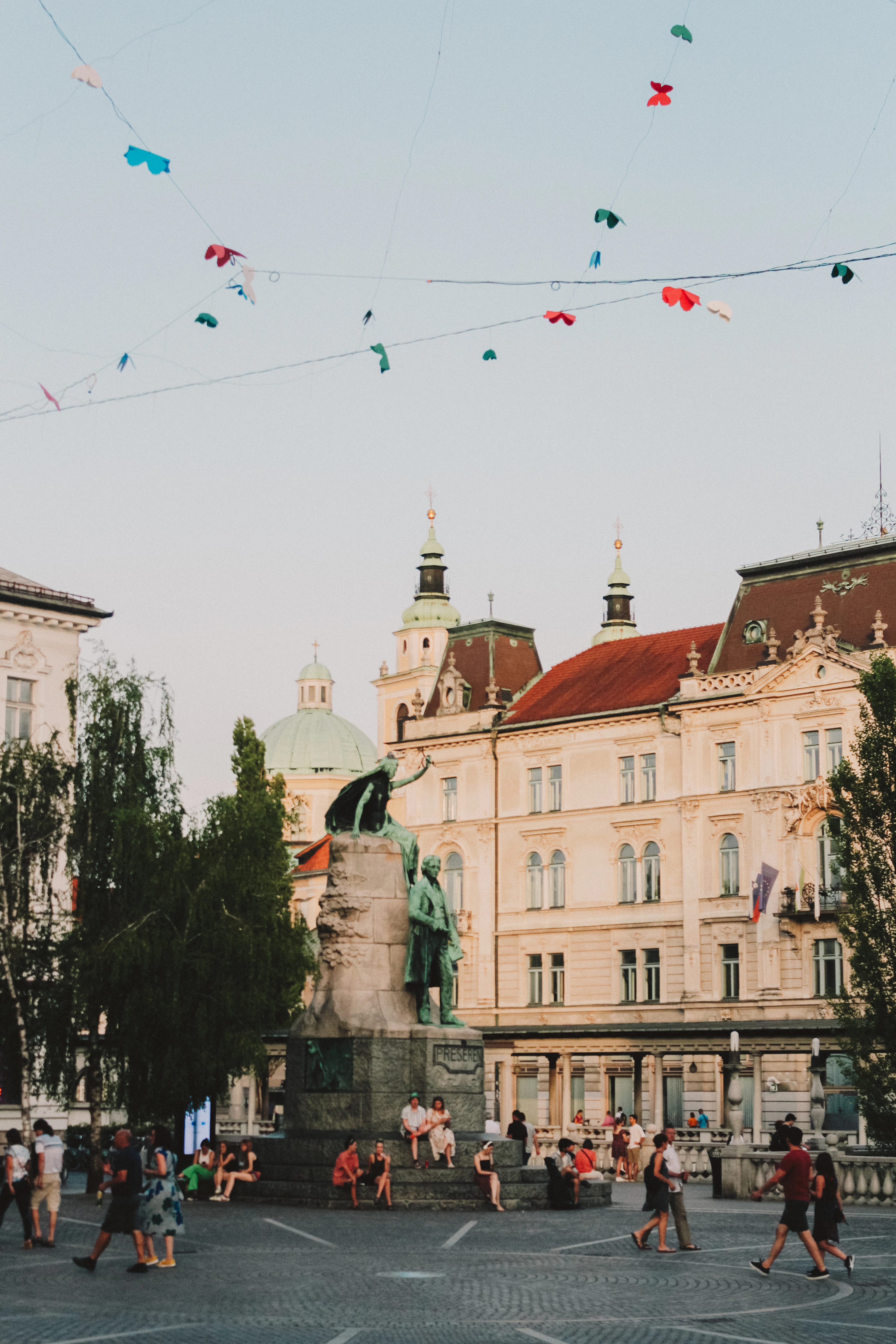Ljubljana's pastel facades around Preseren Square, church towers and treetops above the rooflines
