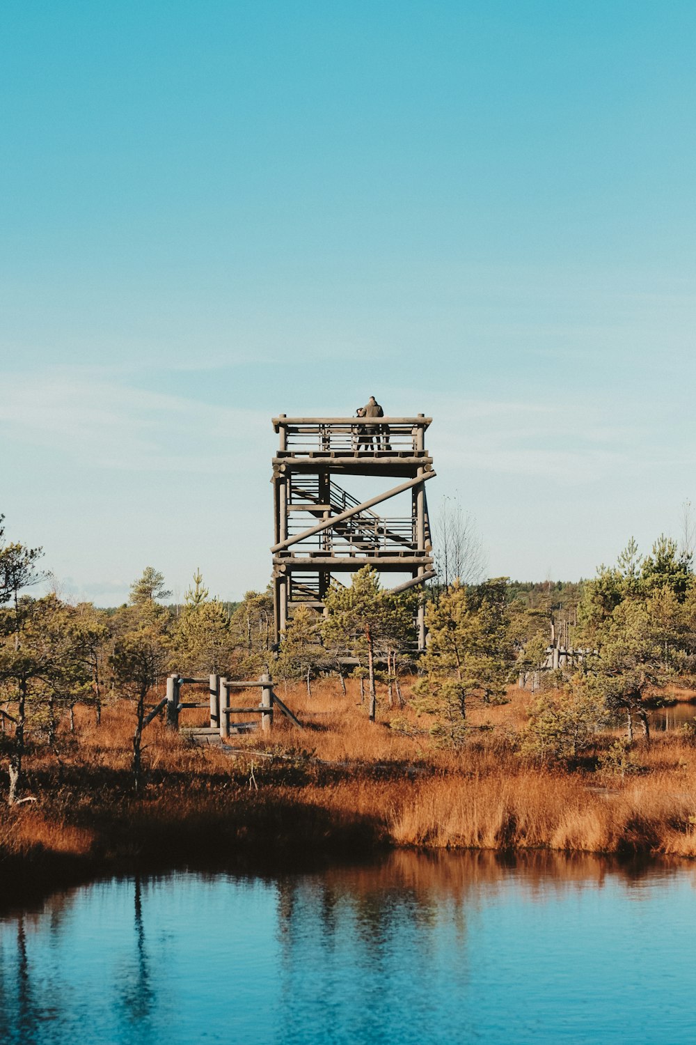 a couple of people standing on top of a wooden structure