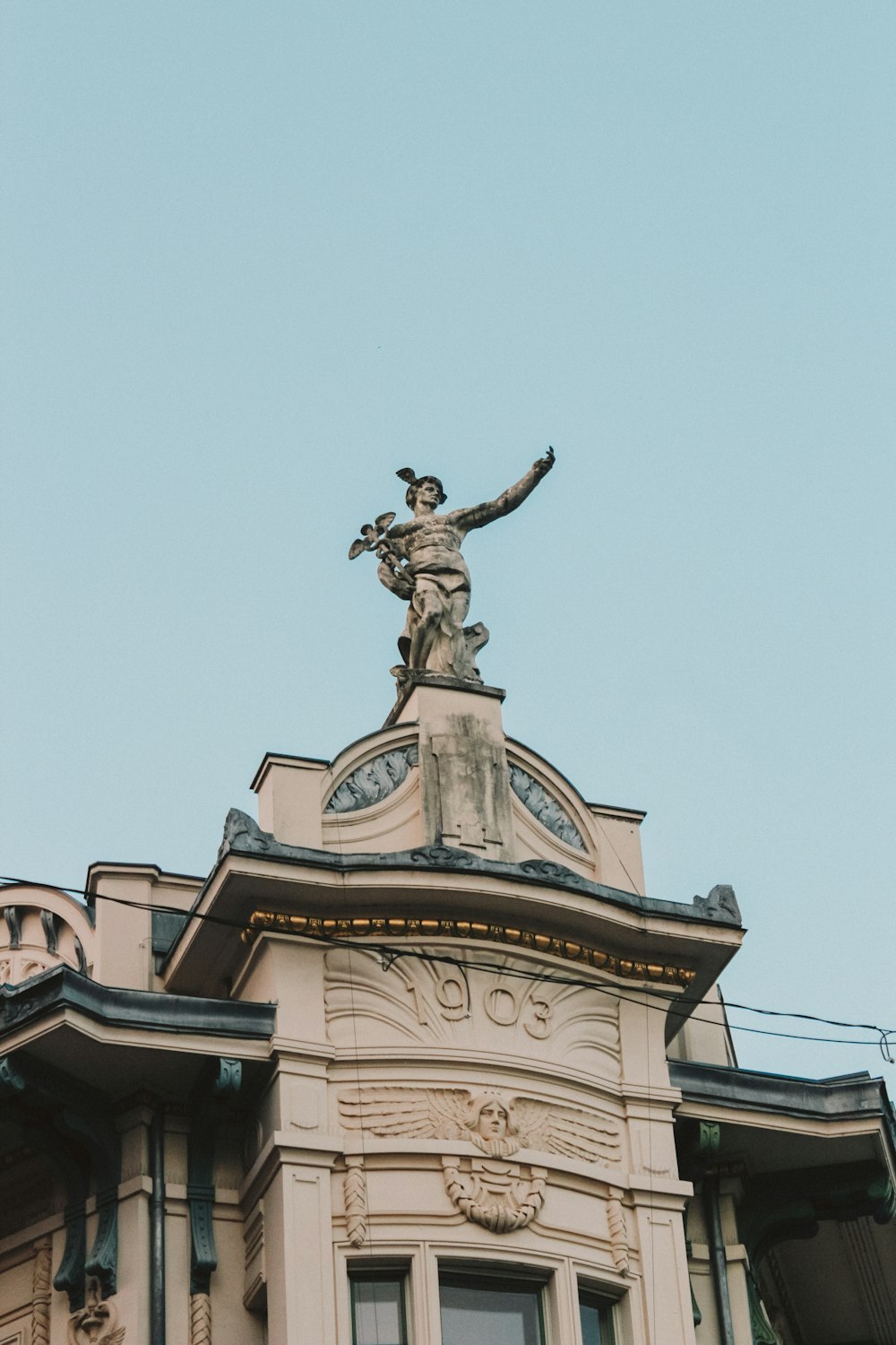 a building with a statue on top of it