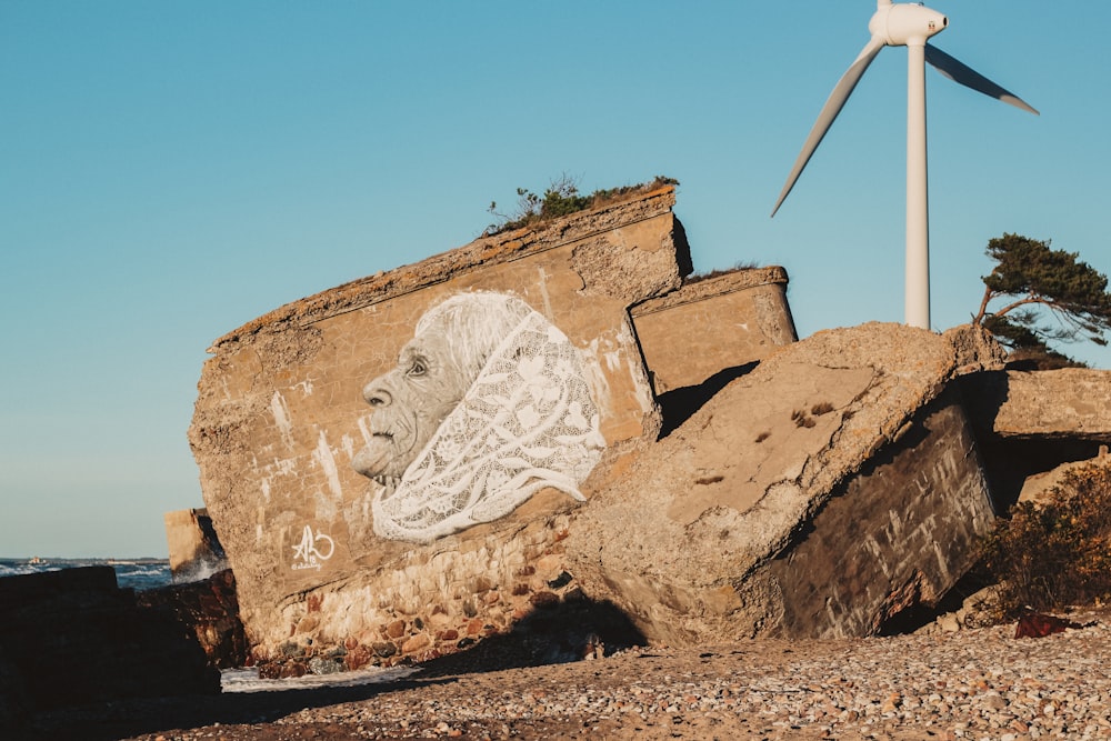 a rock with a painting of a man on it