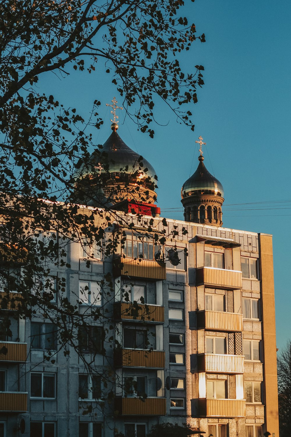 a tall building with two domes on top of it