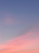 Dreamlike gradient sky with subtle floating objects blending nature and technology motifs