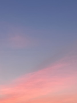 Dreamlike gradient sky with subtle floating objects blending nature and technology motifs