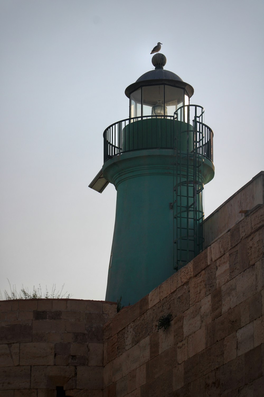 a light house sitting on top of a brick wall