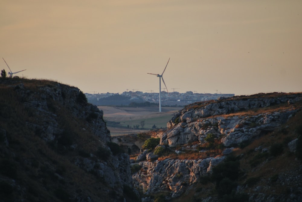 a couple of windmills that are on top of a hill