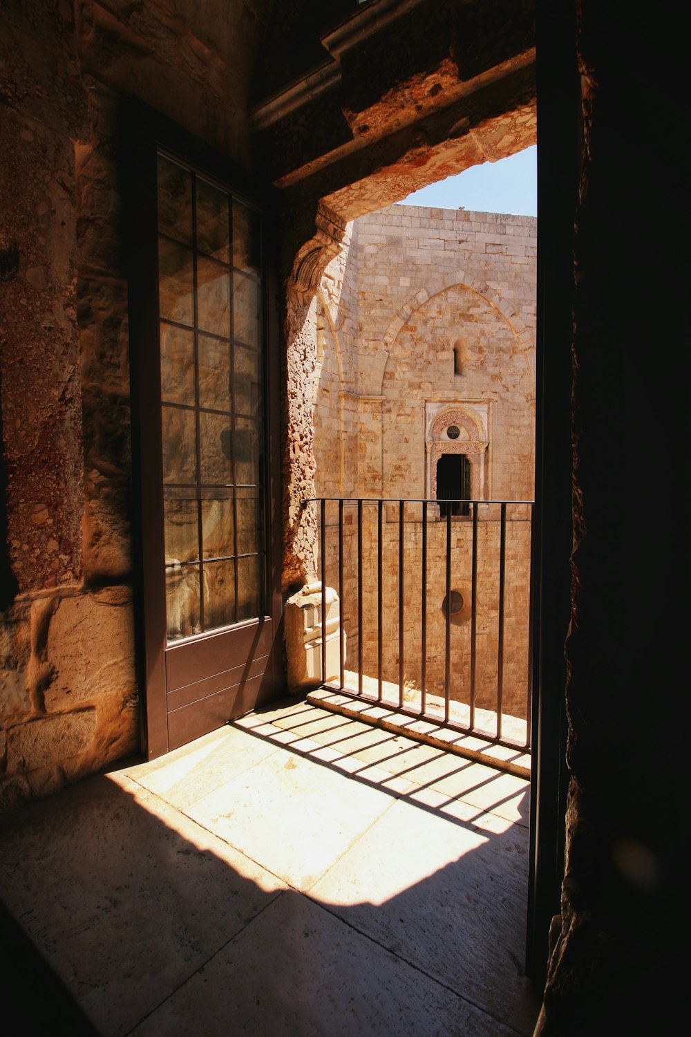 a balcony with a gate and a window