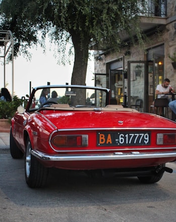 a red sports car parked on the side of the road
