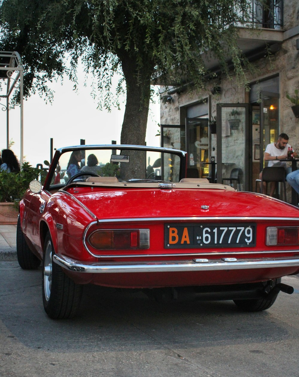 a red sports car parked on the side of the road