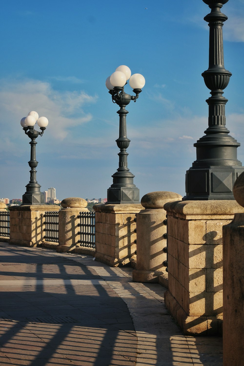 a couple of street lamps sitting on top of a bridge