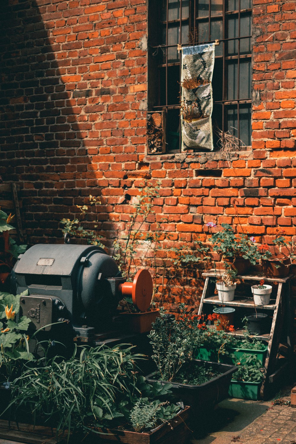 a brick building with a window and a grill