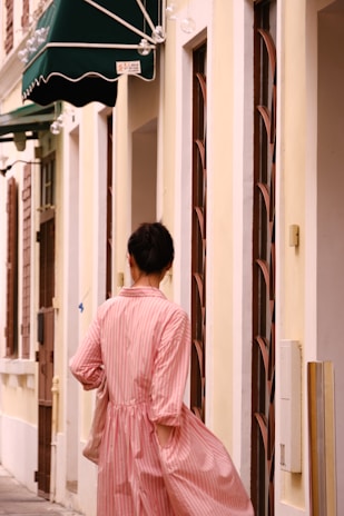Woman wearing soft pastel clothing in a cozy Villa La Angostura street setting.