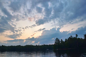 A serene sunrise over a peaceful lake, symbolizing new beginnings.