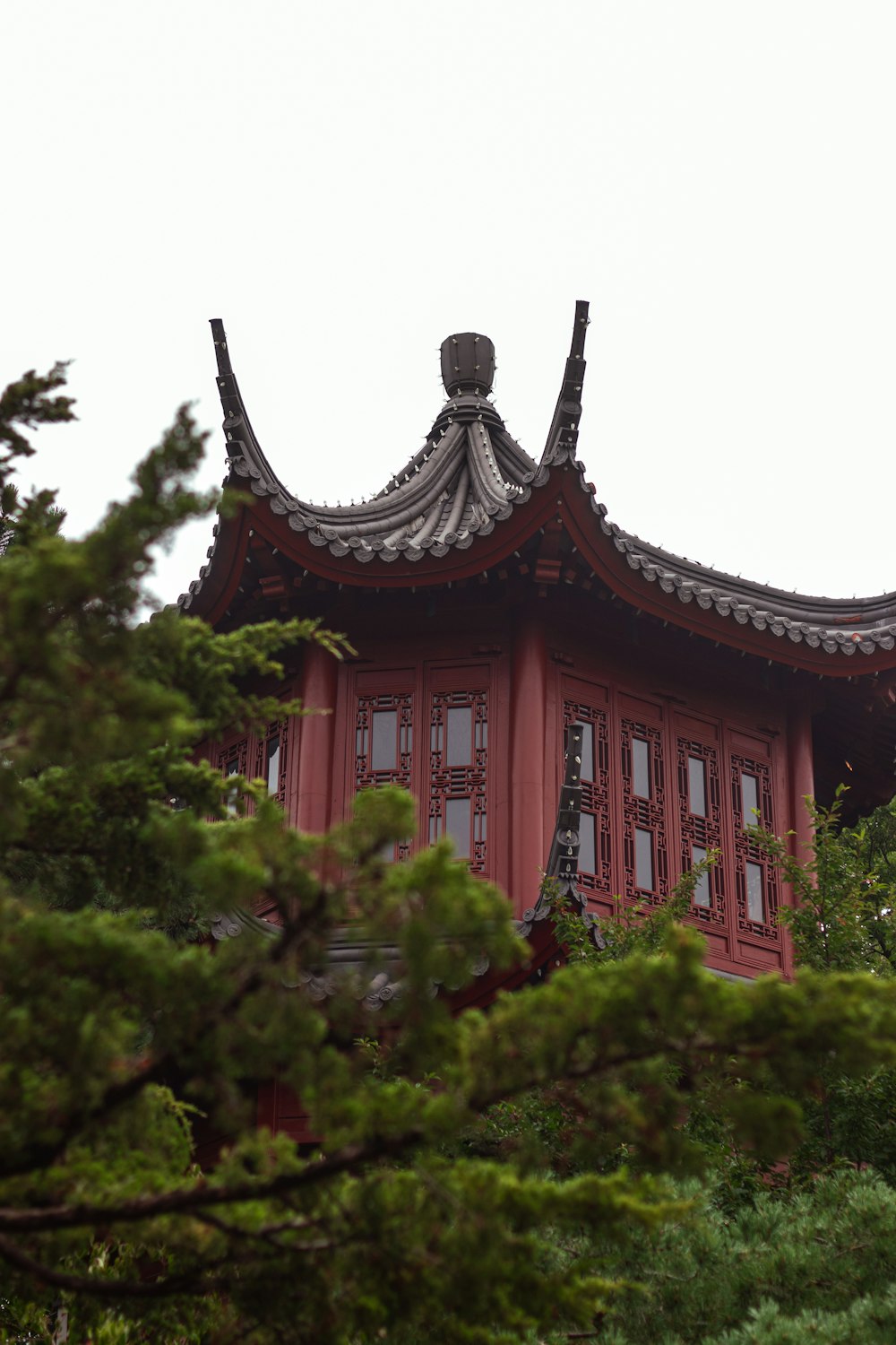 a tall red building with a roof made of wood