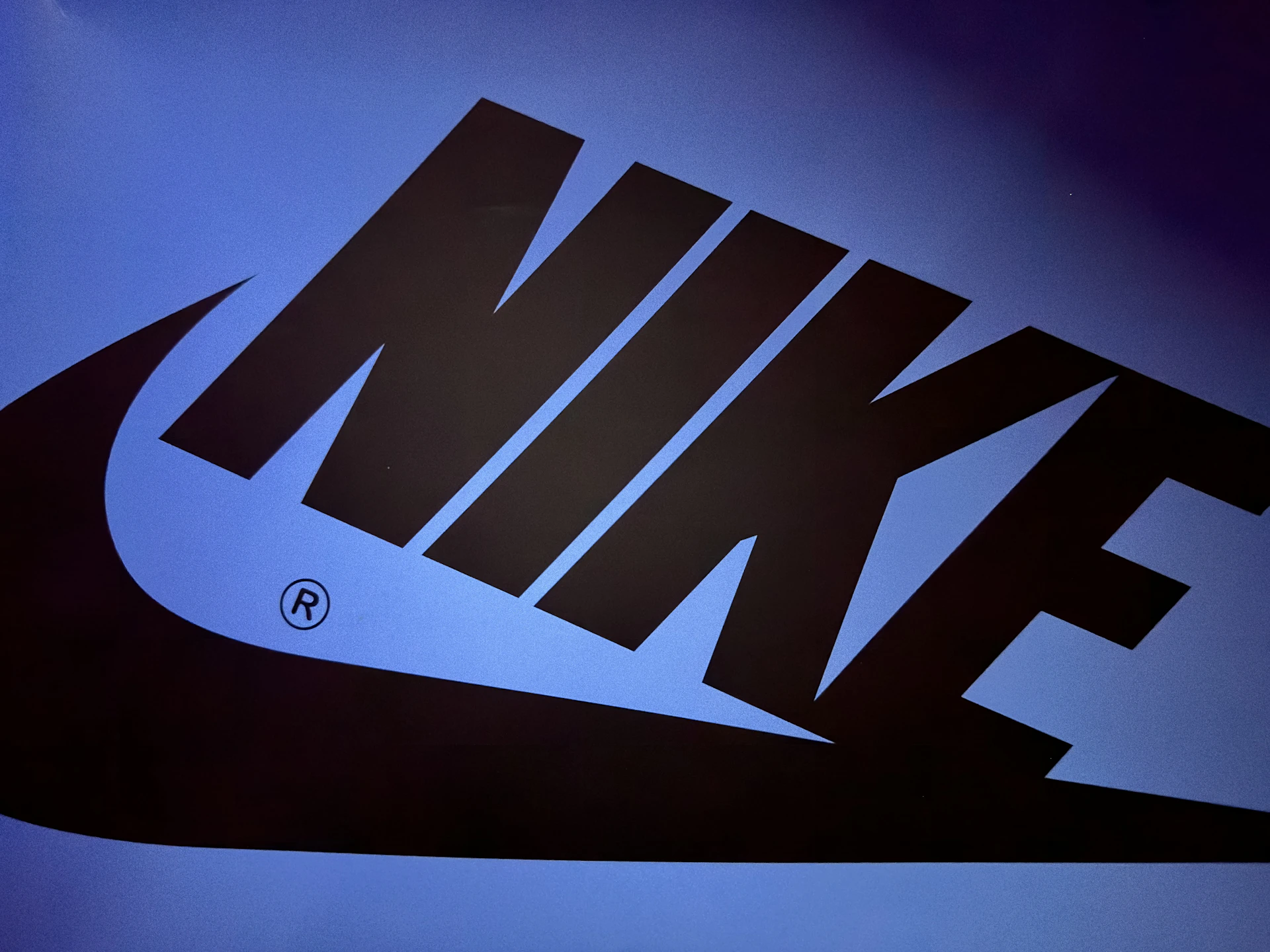 A vibrant carousel slide featuring the bold Nike swoosh logo against a dynamic, sporty backdrop.