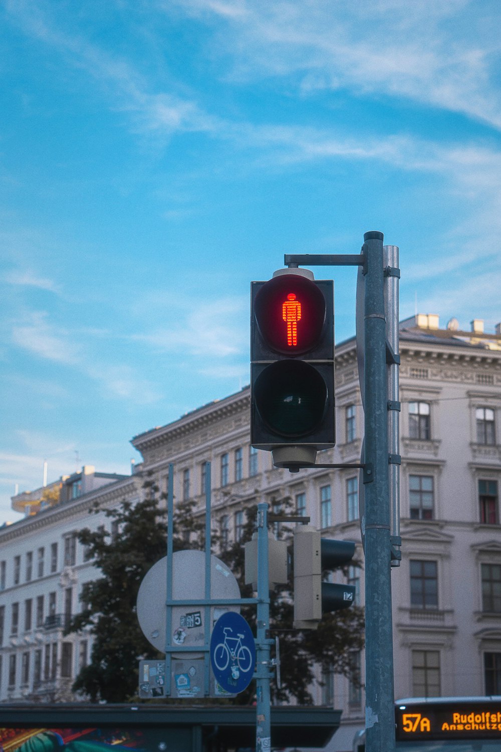 a traffic light on a pole in front of a building