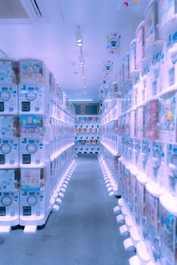 A sleek, futuristic vending machine glowing with neon accents inside a modern gym setting.