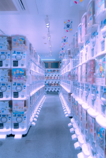 A sleek, futuristic vending machine glowing with neon accents inside a modern gym setting.