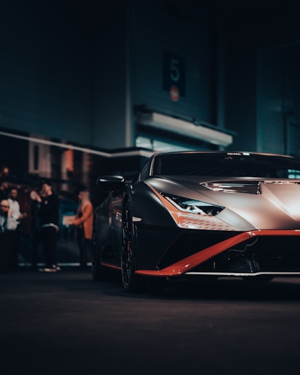A sleek Corvette C8 in a dark studio, showcasing subtle carbon fiber details and a flawless custom finish.