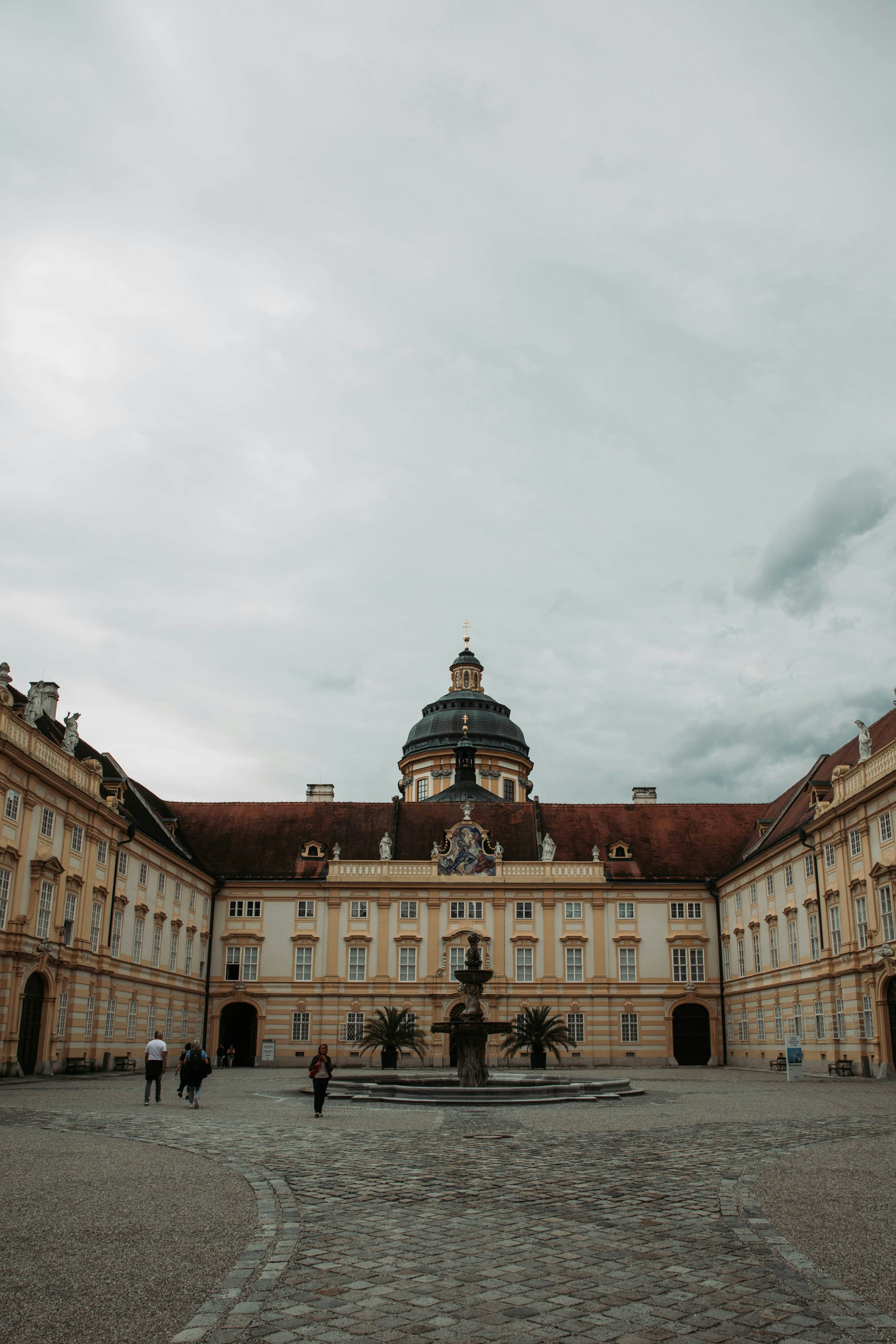 A large building with a fountain in front of it photo – Free Portrait ...